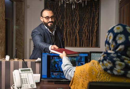 Free A professional exchange of a folder between colleagues in a modern office environment. Stock Photo