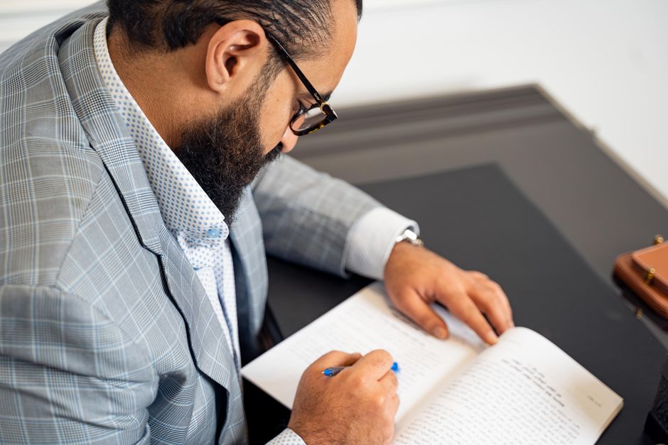 Property consultant reviewing real estate documents with buyers in a Gurgaon office