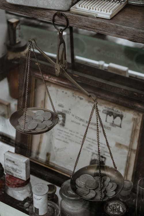 Free Silver Coins on an Antique Weighing Scale Stock Photo
