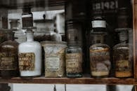 Assorted Vintage Bottles on a Wooden Shelf