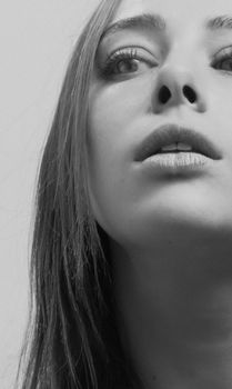Elegant black and white portrait capturing the serene expression of a young woman.