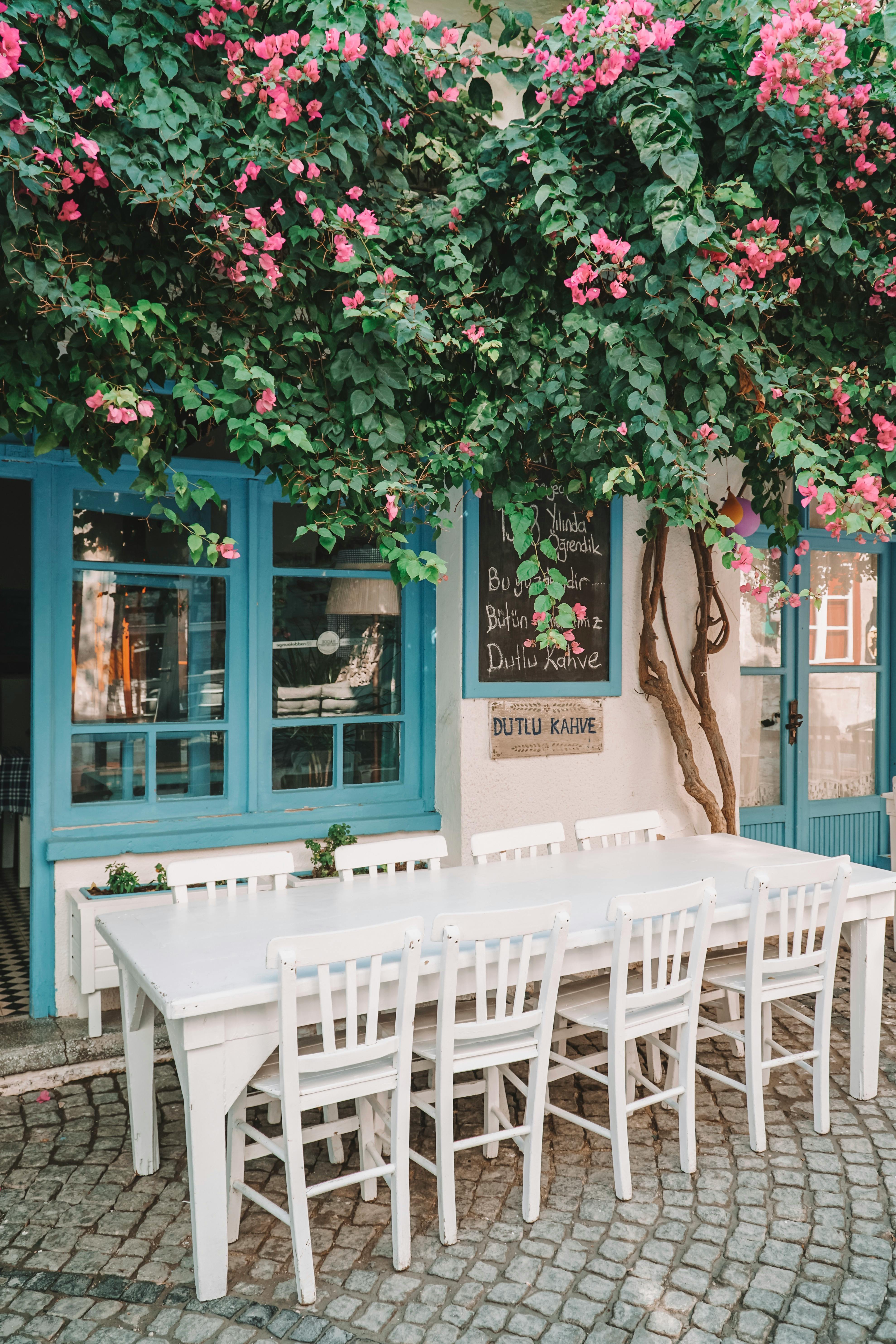 white wooden chairs and table near the door