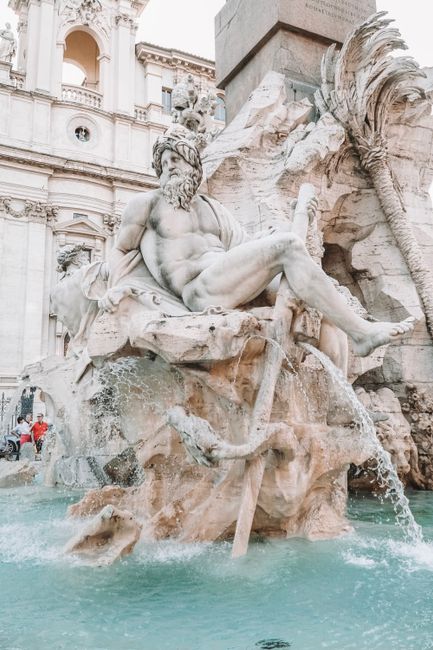 Captivating ancient Roman statue in a grand water fountain in Rome, Italy.