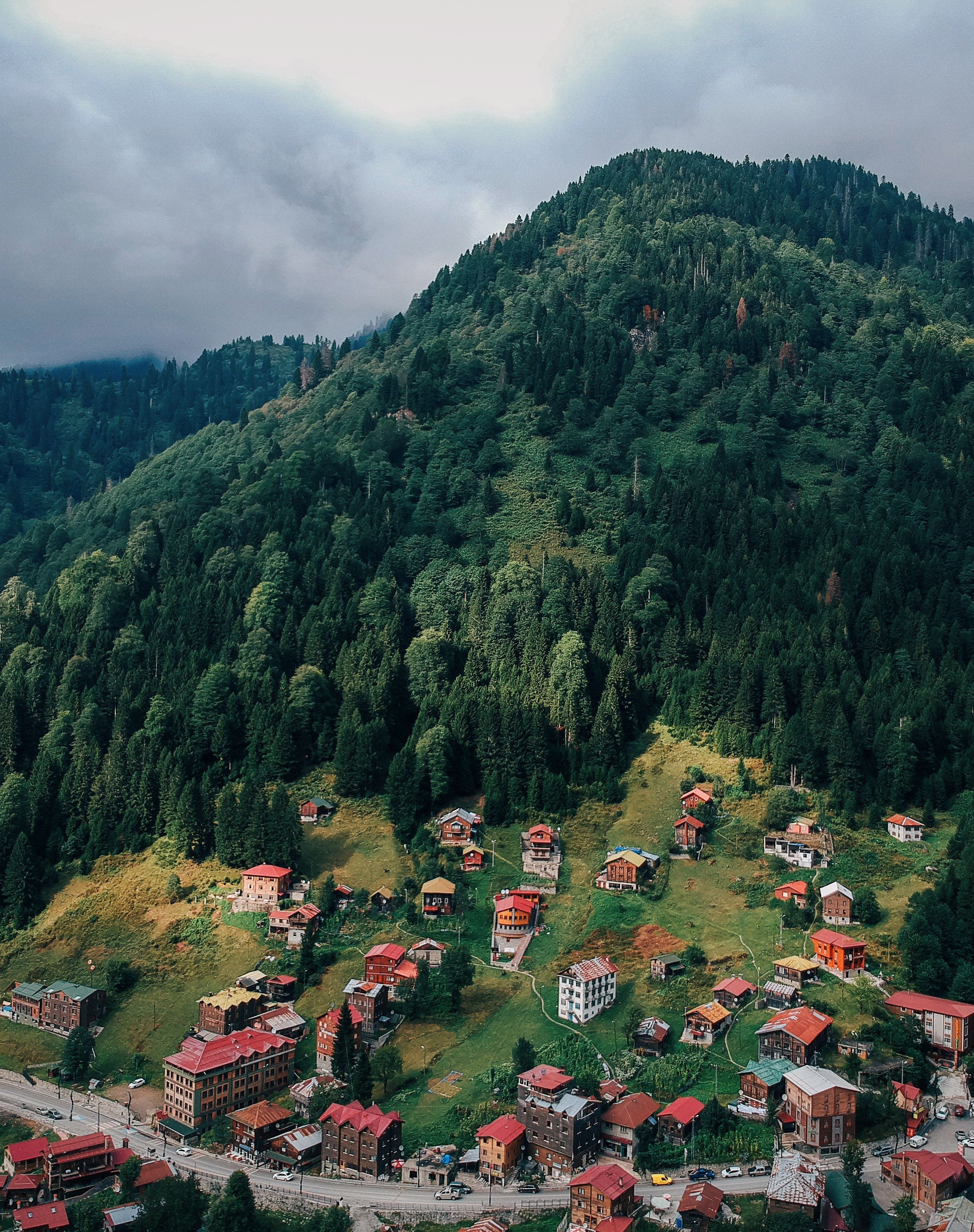 Aerial Photography of Houses under the Mountain · Free Stock Photo