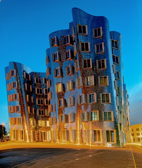 Free Futuristic Gehry Buildings in Düsseldorf illuminated under a clear night sky. Stock Photo