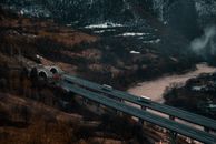 Trucks on a Highway Bridge Over a Body of Water