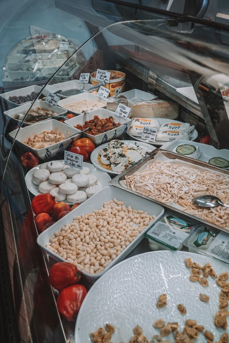 Assorted Food In A Glass Display Refrigerator