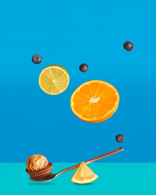 Free Vibrant composition of various fruits and chocolate on a blue background for healthy food concepts. Stock Photo