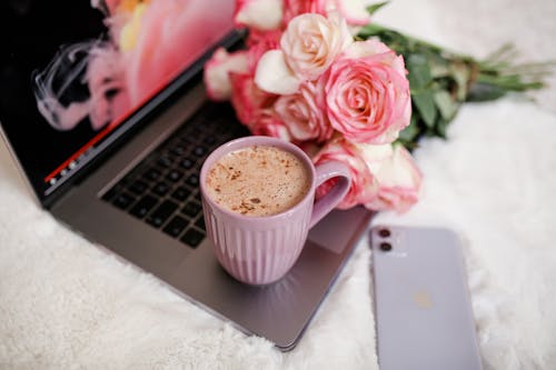 Free White Ceramic Cup on the Laptop Stock Photo
