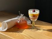 Photo of a Drink Near a Jar of Honey