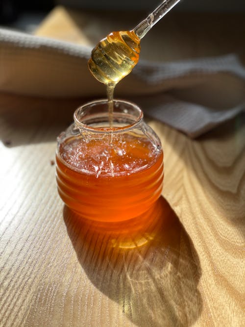 Close-Up Shot of a Glass Jar with Honey