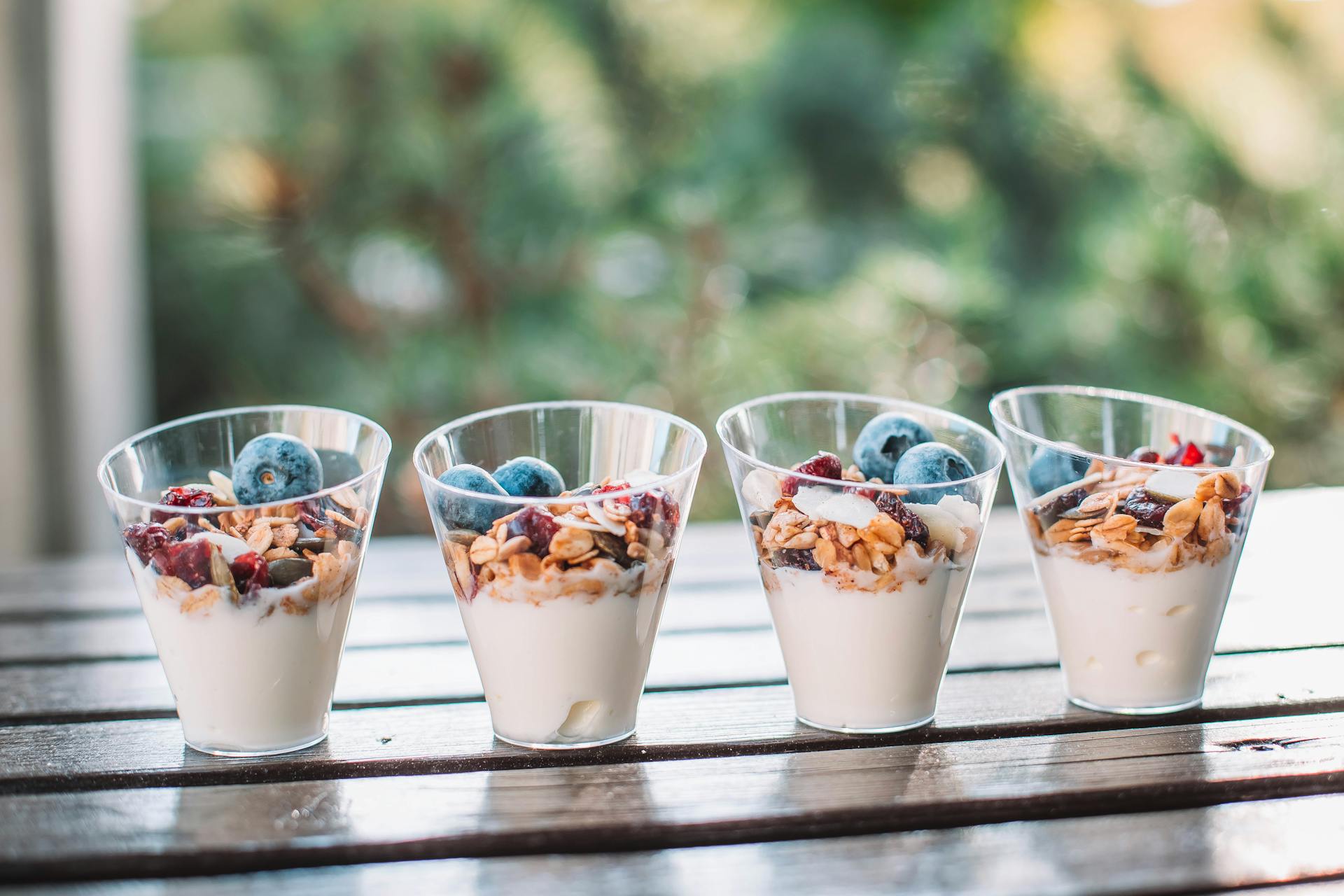 Healthy yogurt parfaits topped with fresh blueberries, nuts, and granola.