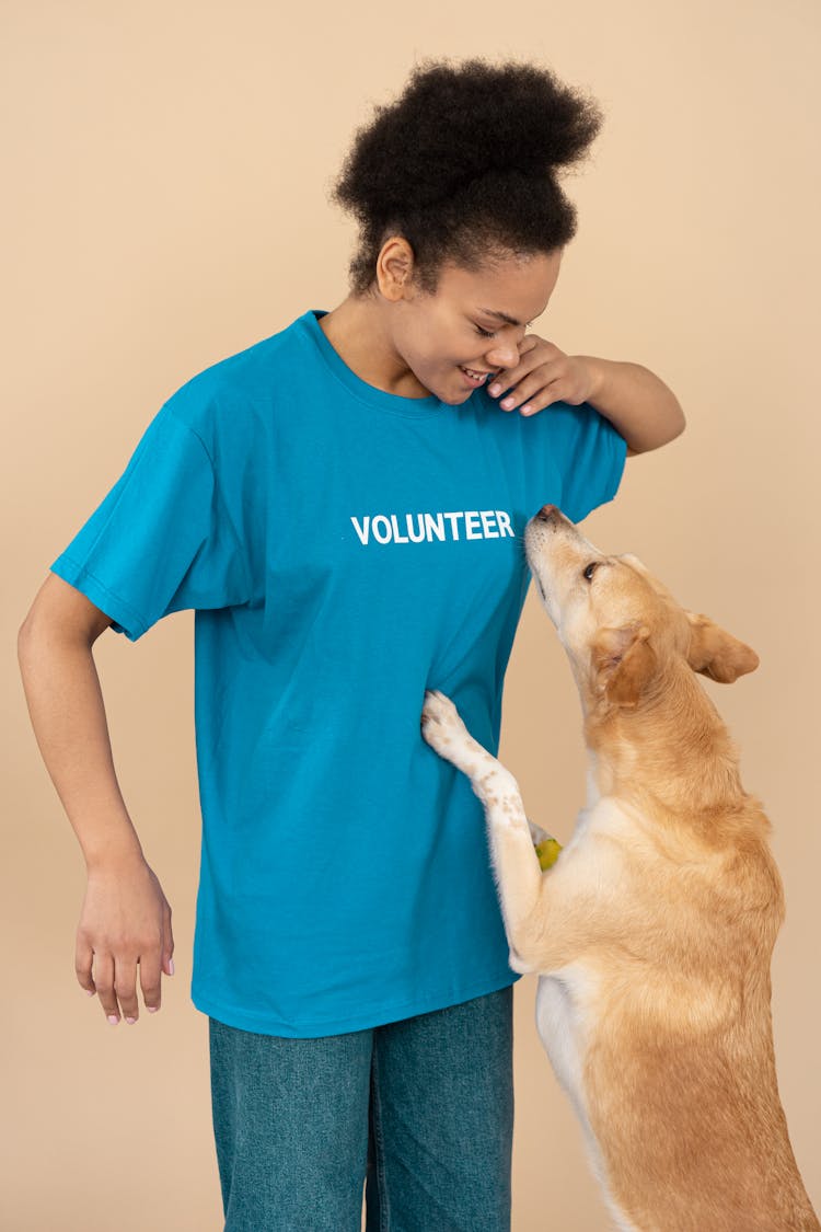 A Woman Playing With A Dog