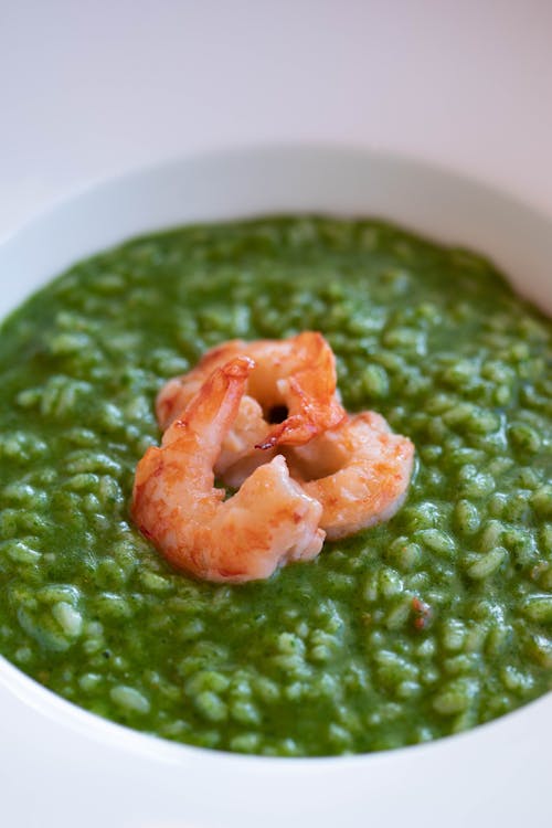 Free High angle of delicious pesto risotto with shrimps served in bowl for lunch Stock Photo