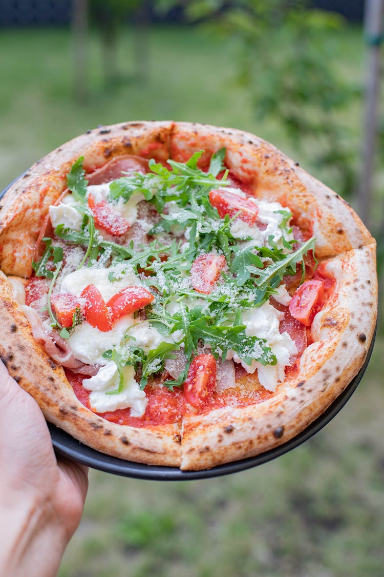 Crop Person Showing Tasty Pizza