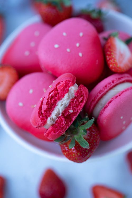 Macaroons and strawberries on plate