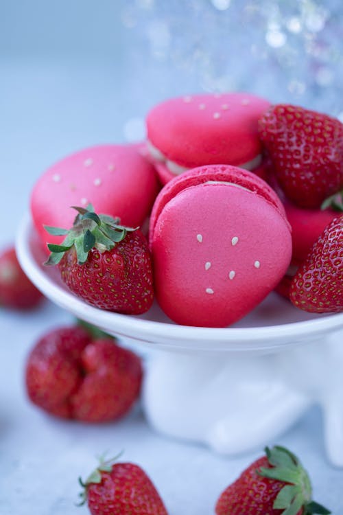 Fresh strawberries and macaroons on plate