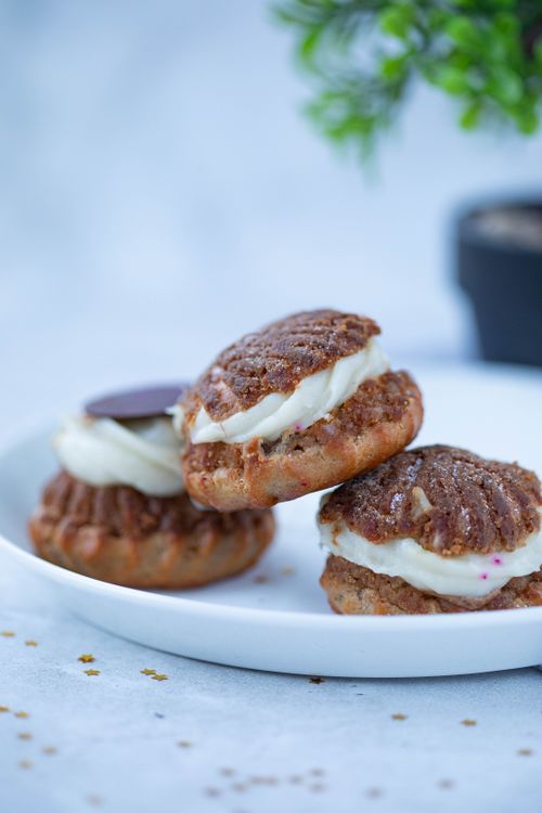Free Pile of tasty craquelin choux pastries placed on white plate against blurred background Stock Photo