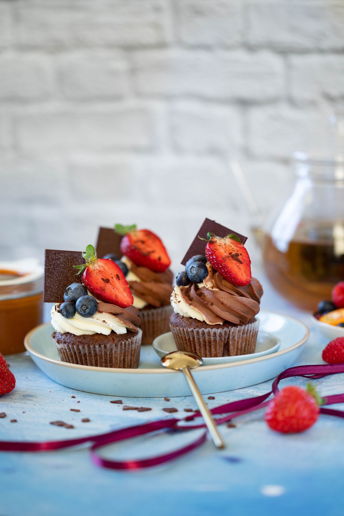 Mini chocolate cakes topped with berries and cream