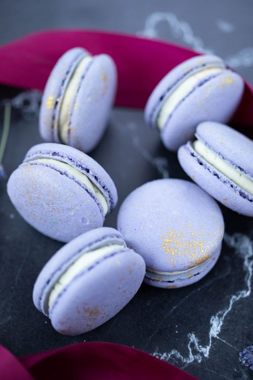 Free From above of gentle blue macaroons with tender cream placed on surface with patterns Stock Photo