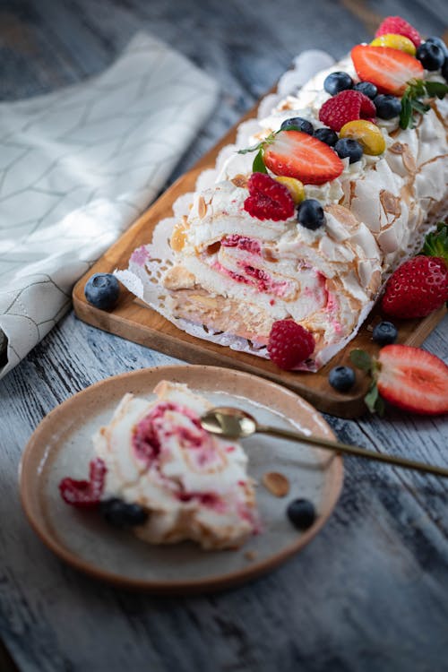 From above of tasty dessert with red strawberry placed on gray wooden table