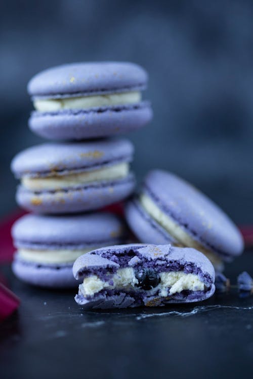 Sweet delicate appetizing purple macaroons on table on blurred background in daylight in kitchen