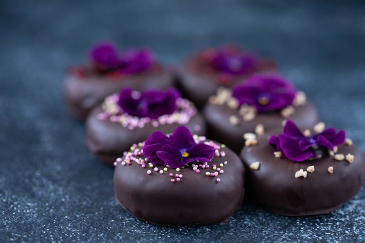 Set Of Sweet Doughnuts With Chocolate Glaze Decorated With Viola Flower