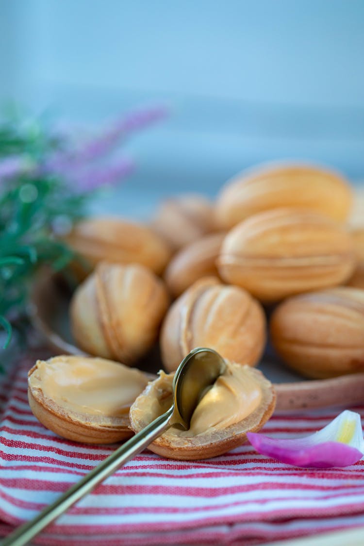 Walnut Cookie With Condensed Milk On Plate Near Spoon