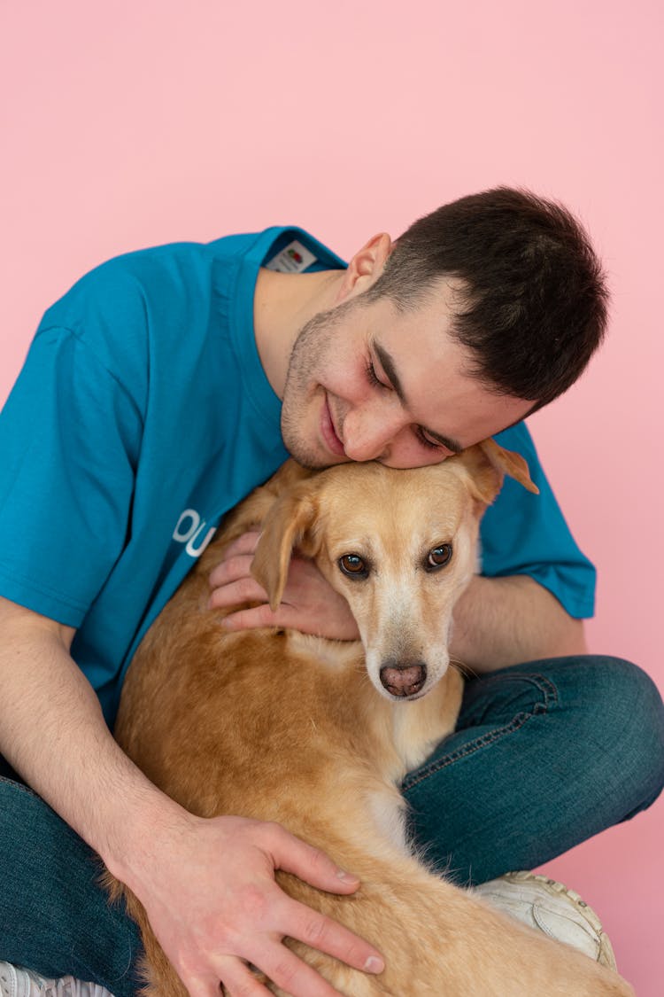 Man Hugging A Dog