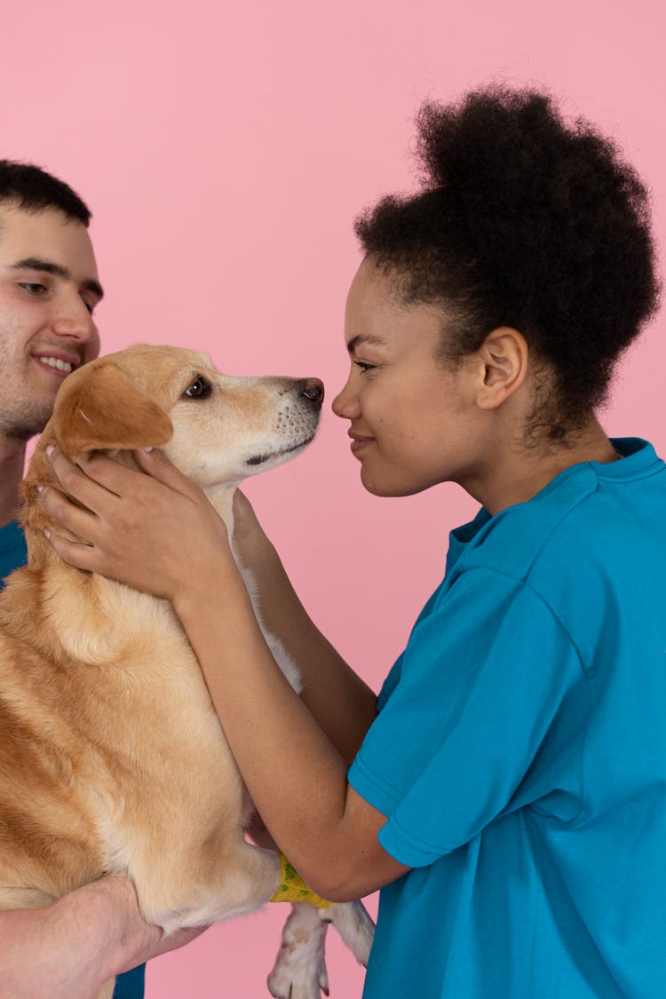 A Woman Kissing A Dog