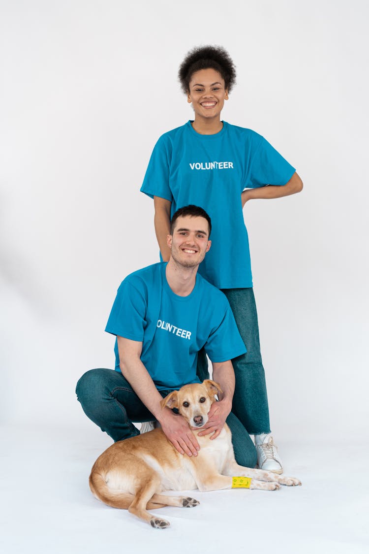 A Man And A Woman With Their Pet Dog