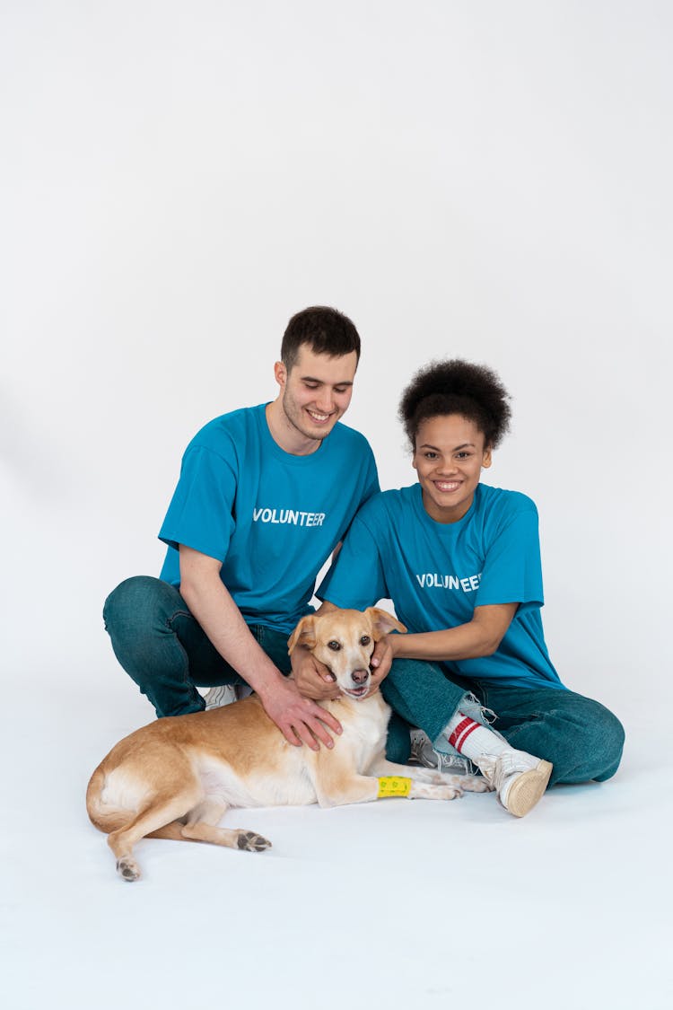 A Man And A Woman With Their Pet Dog 