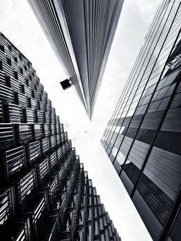 A striking low angle view of modern skyscrapers in downtown London, emphasizing architecture and perspective.