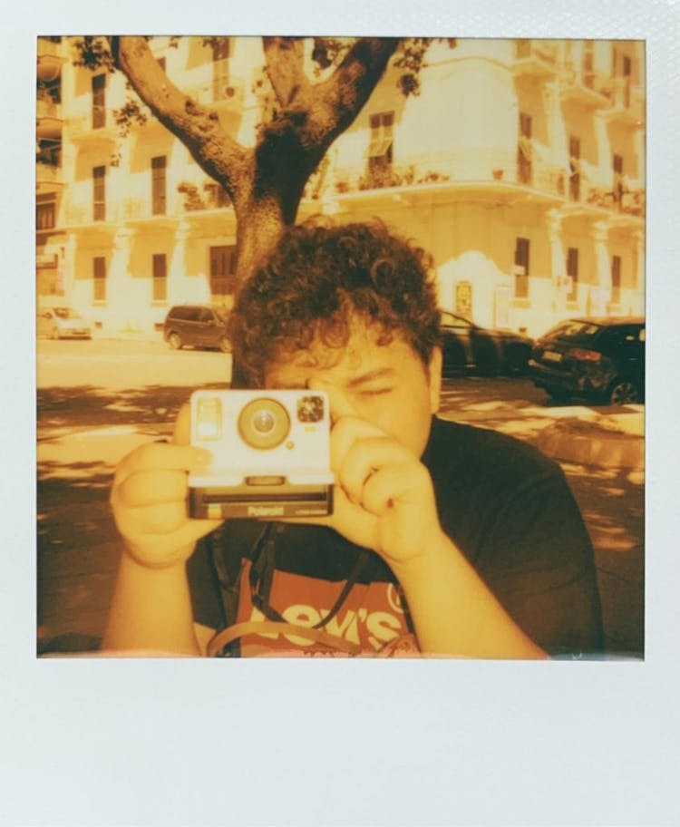 Polaroid Photo Of A Man Taking Photos Using A Vintage Camera