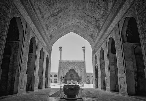 Explore the intricate architecture of Isfahan's historic mosque with its famous arches and towers.