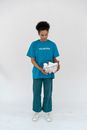 Man in Blue Crew Neck T-shirt and Blue Denim Jeans Holding White Paper