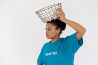 Woman in Blue Crew Neck T-shirt Holding White and Black Checkered Throw Pillow