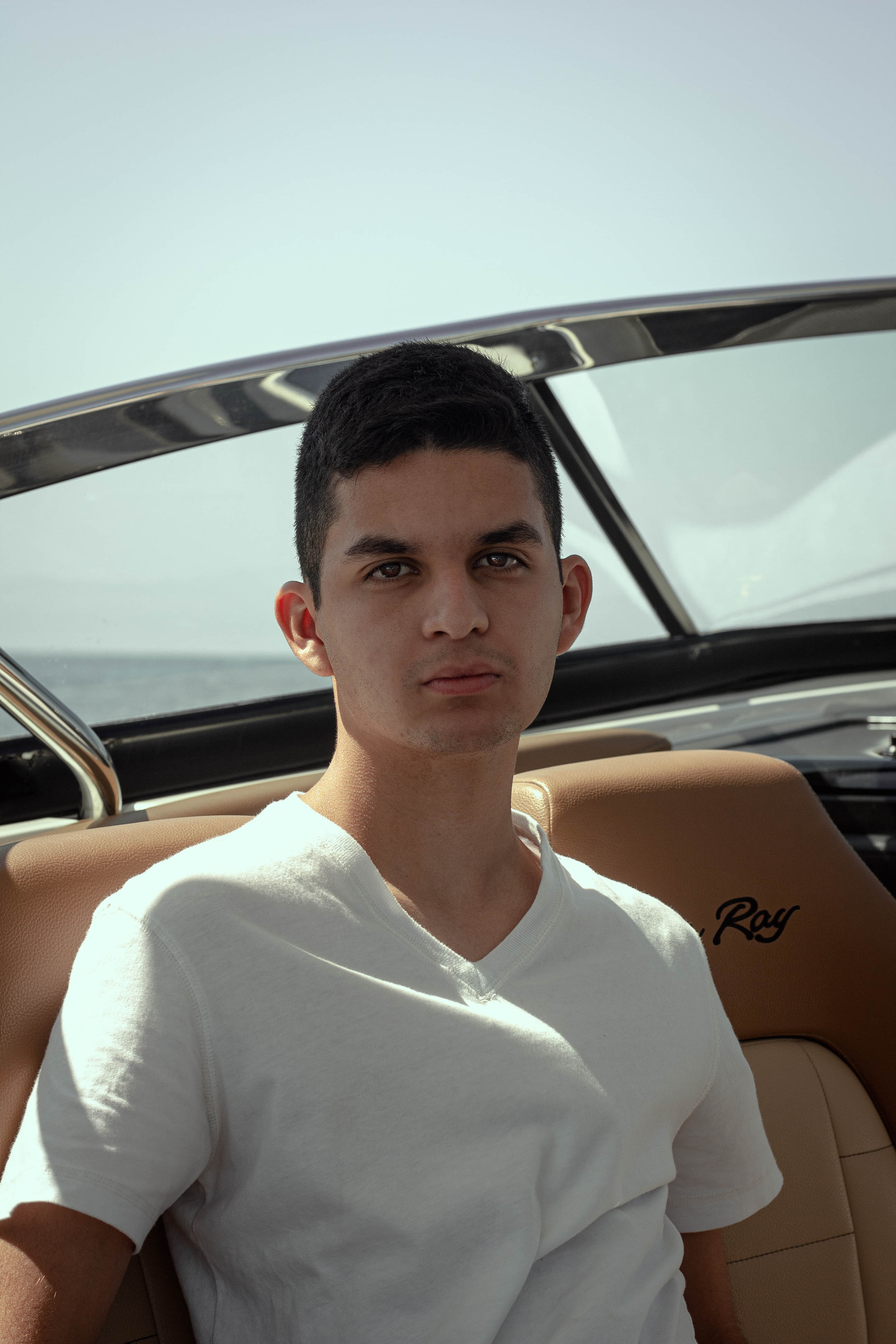 Portrait of a young man enjoying a sunny day on a yacht. Perfect for lifestyle contexts.
