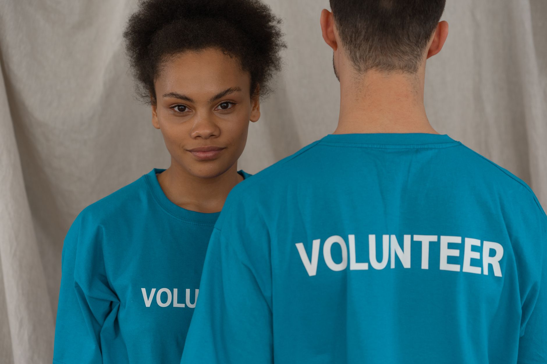 Woman Standing Near the Person While Wearing Blue Shirt