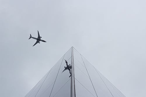 Airplane in Mid Air Under Cloudy Sky