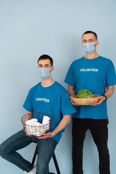 Man in Blue Crew Neck T-shirt Holding Corn