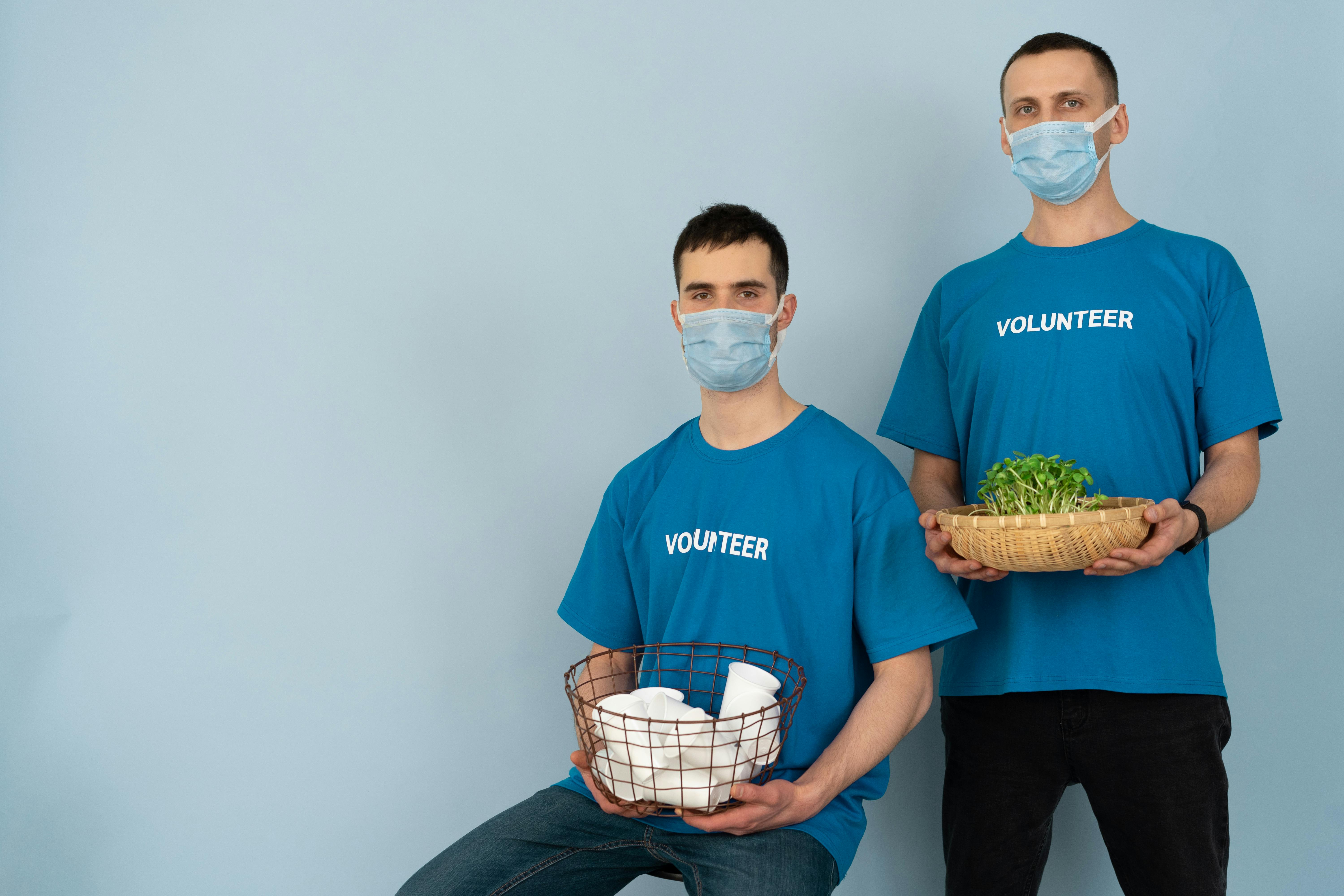 man in blue crew neck t shirt holding green and white basket