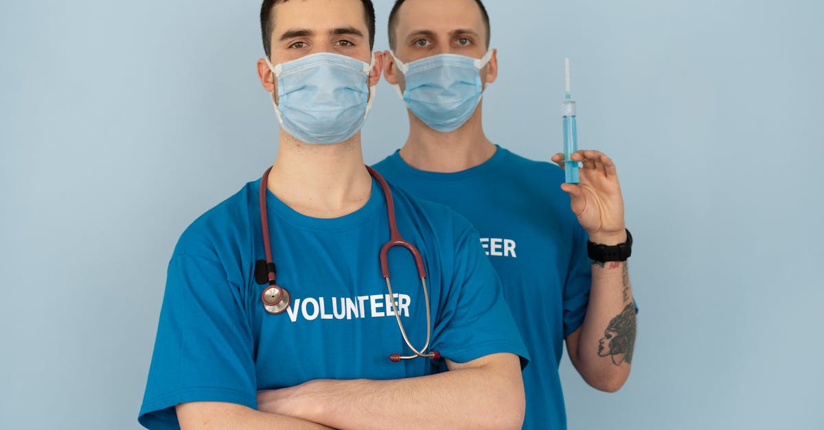 Man in Blue Crew Neck T-shirt With White Face Mask