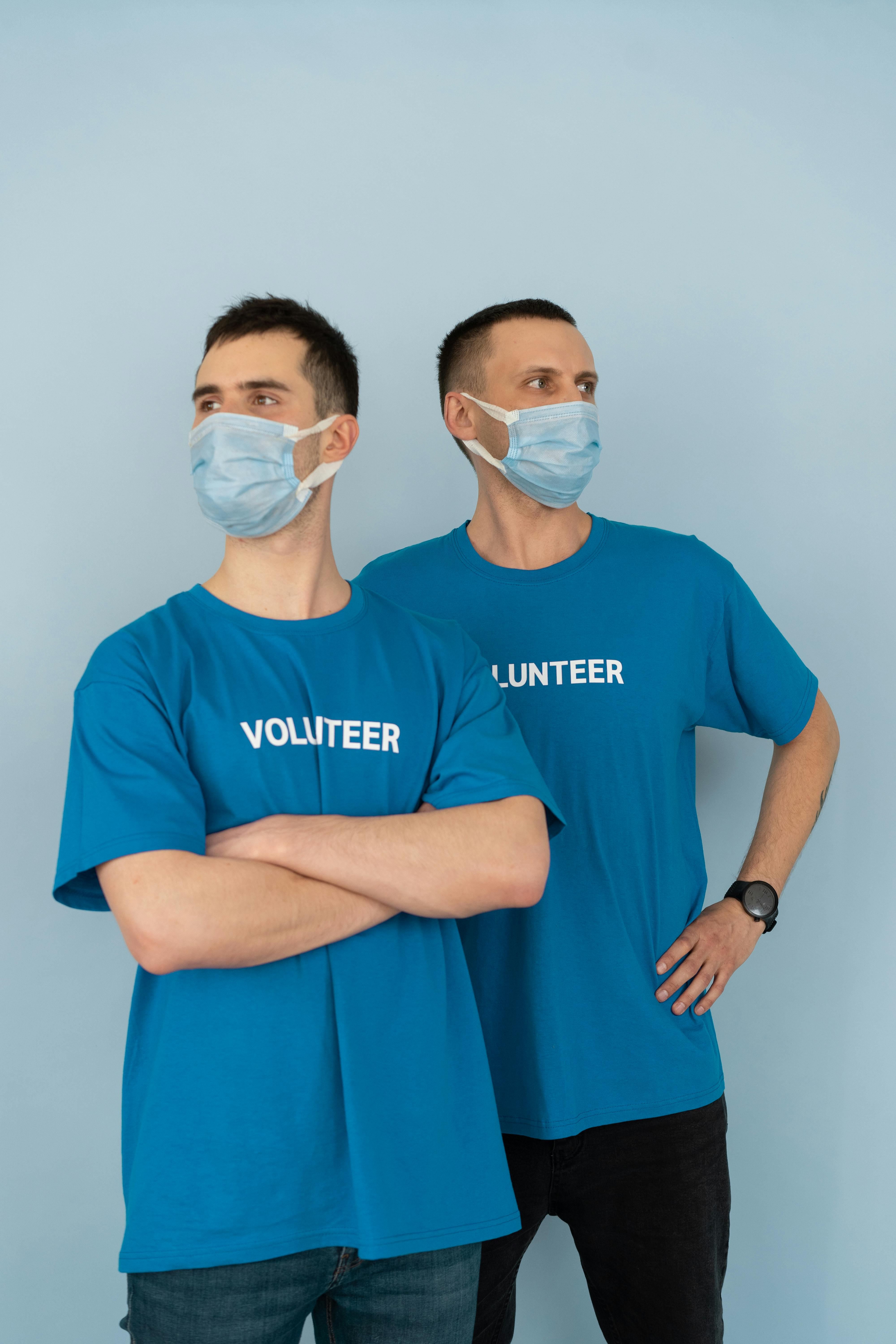 photo of men with face masks wearing volunteer shirts