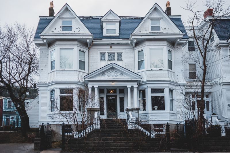 Classic white home exterior behind a first time buyer testimonial