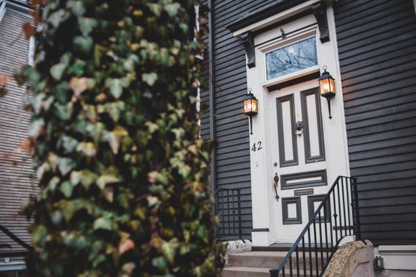 House entrance with lit porch lanterns