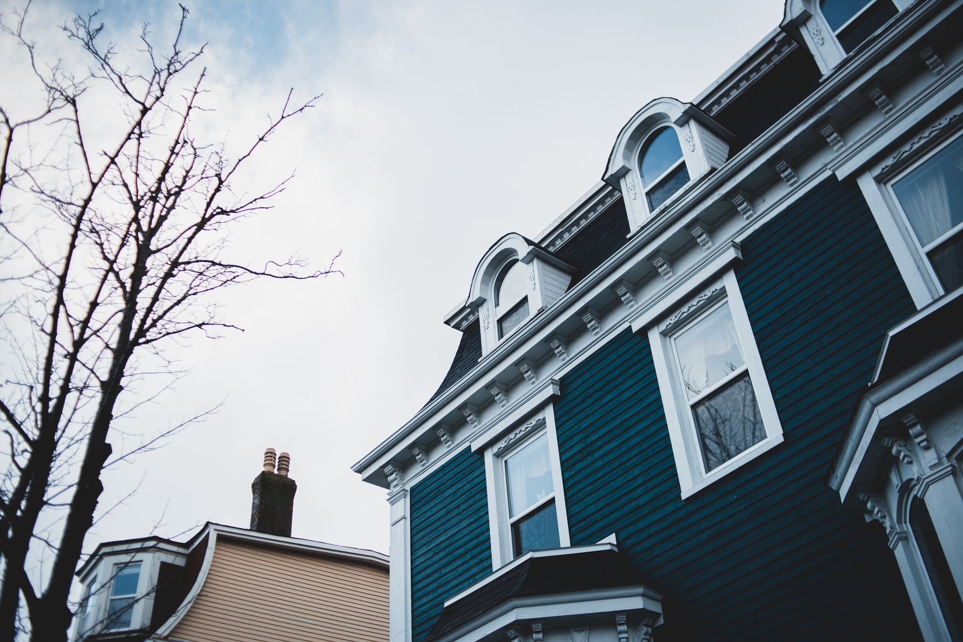 Classic Victorian house with intricate facade details and urban charm, captured in an outdoor setting.