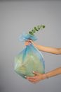 Person Holding Blue Plastic Bag
