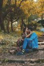 A Woman Kissing a Man's Forehead while Sitting at a Park