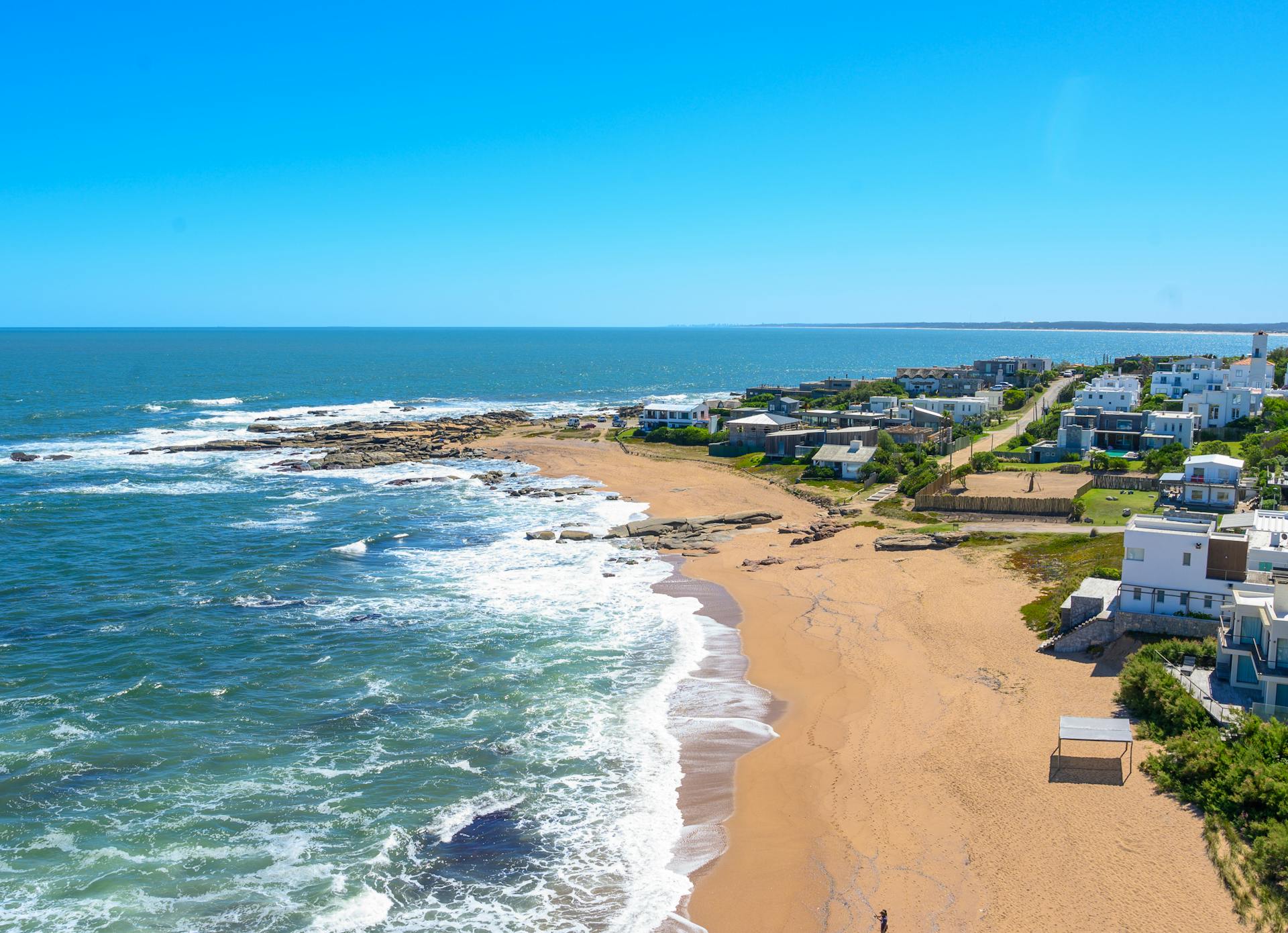 Stunning aerial view of José Ignacio beach in Uruguay with clear blue waters and sandy shores.